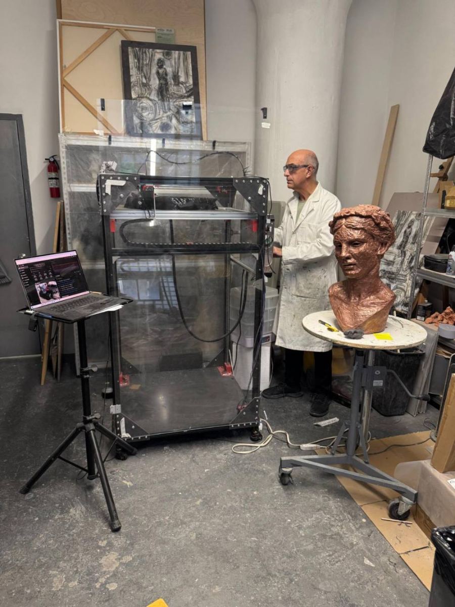 George Petrides beside the large-format printer developed by PPS